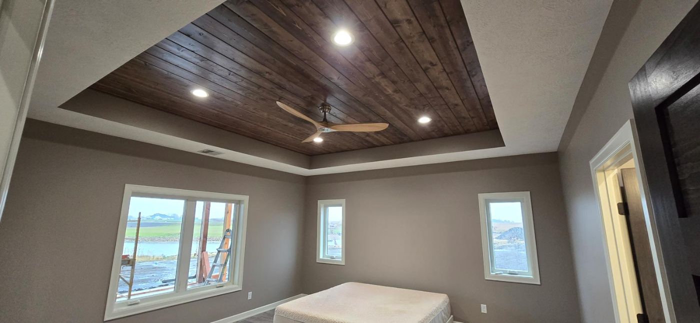 Custom home interior with vaulted ceiling and stone fireplace, built by Hahn Custom Homes